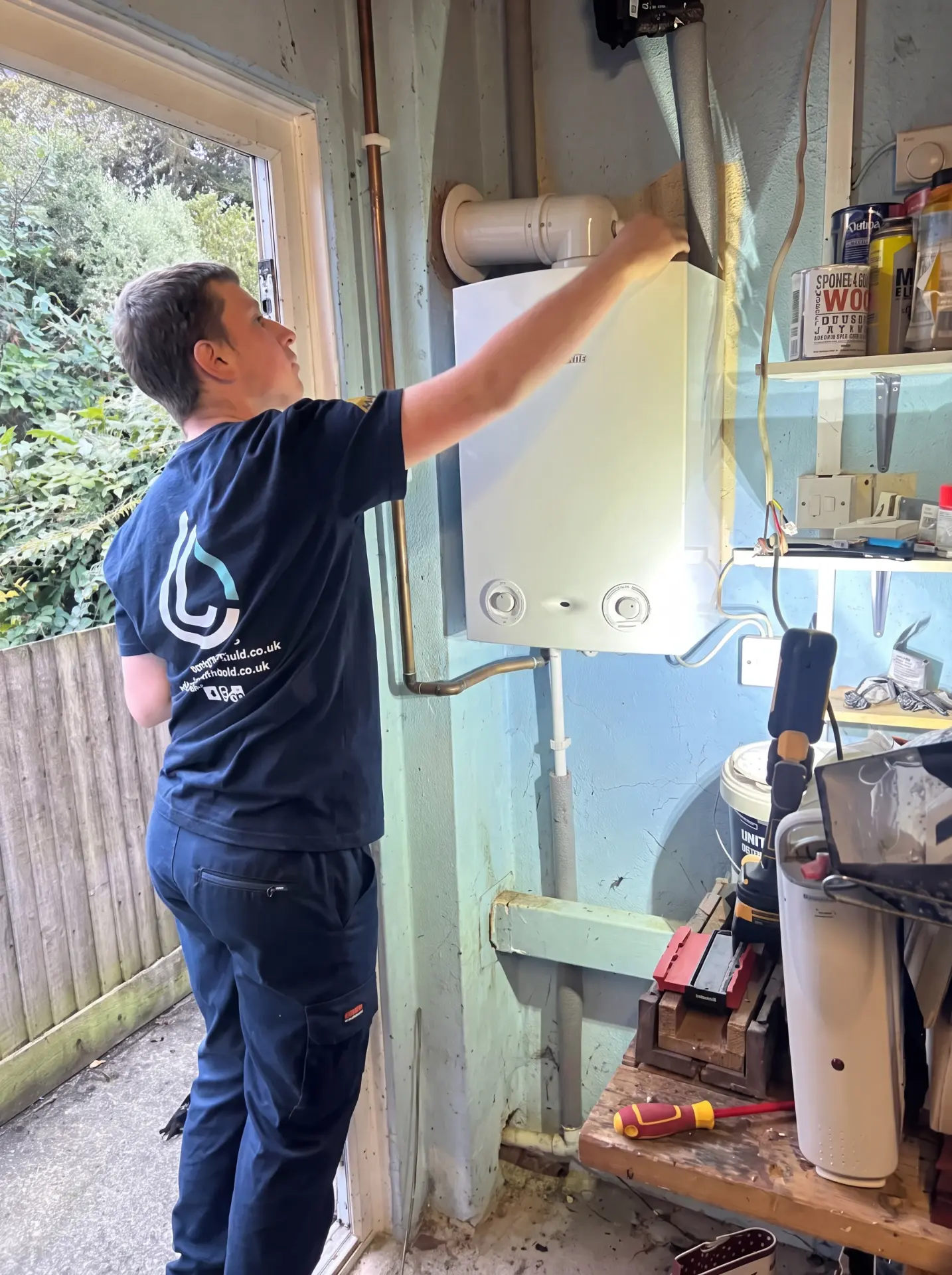 Lock & Lindfield engineer commissioning a new boiler in a garage